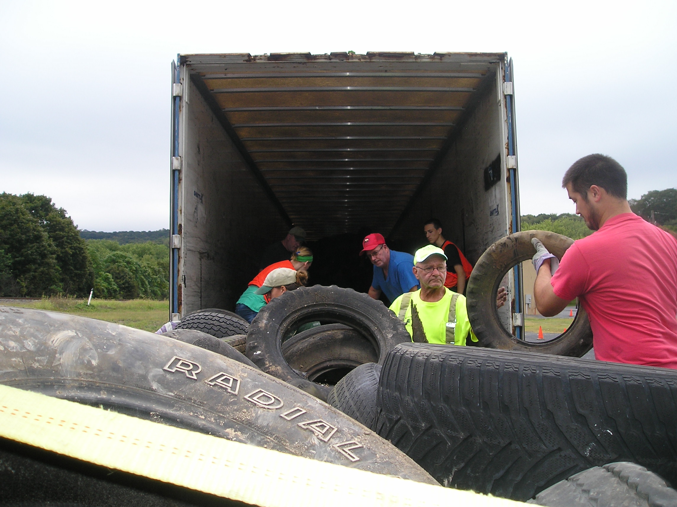 Men loading tires into a truck